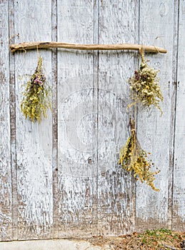 Bouquet of flowers hanging on driftwood outside