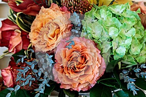 Bouquet of flowers including roses, orchids, pincushion proteas