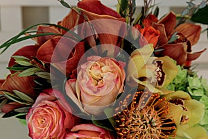 Bouquet of flowers including roses, orchids, pincushion proteas