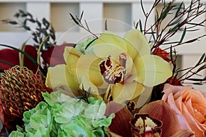 Bouquet of flowers including roses, orchids, pincushion proteas