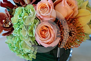 Bouquet of flowers including roses, orchids, pincushion proteas