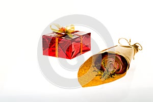 Bouquet of flowers in parchment paper and wrapped gift on a whit