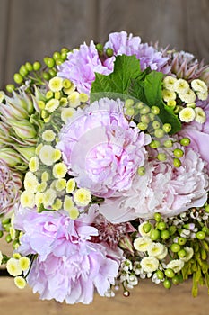 Bouquet of flowers: peony, matricaria and serruria florida blushing bride