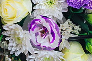 A bouquet of flowers in purple tones with a bud of eustoma and chrysanthemum