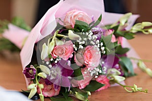 Bouquet of flowers roses in soft focus on light pastel background indoor close-up macro.