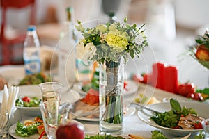 Bouquet of flowers on the served wedding table