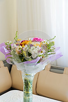 Bouquet of flowers on table in the room