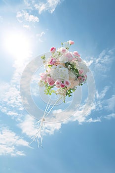 Bouquet of flowers tossed into the air under blue sky. AI Generated