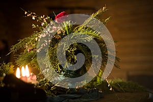 Bouquet of flowers in a vase, candles on a tray, vintage home decor on an a table, dark tones