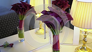 Bouquet of flowers of violet purple callas. Wedding bouquet of the bride. Morning preparations of the newlyweds. Floral