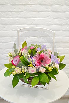 Bouquet of flowers in a white wooden box