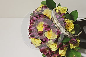 Bouquet of flowers with yellow roses and bow for hair photo