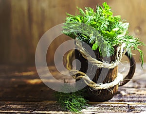 Bouquet of fragrant herbs of fennel and parsley, on a wooden background