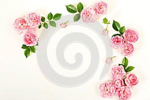 Bouquet frame of beautiful pink roses on white wooden background