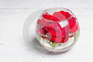 Bouquet of fresh red roses in glass vase