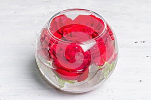 Bouquet of fresh red roses in glass vase