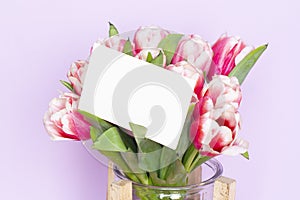 Bouquet of fresh red-white tulips with a card for your text. Gift for romantic date. Tender spring flowers. Bunch of tulips for