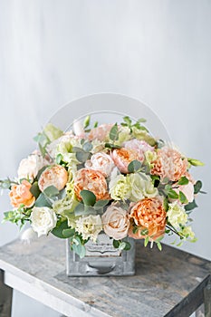 Bouquet of fresh spring flowers on gray wall background. Floral arrangement in vintage metal vase. flower shop, florist