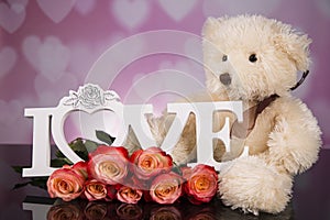 A bouquet of haber roses and a teddy bear mascot. Valentine`s Day