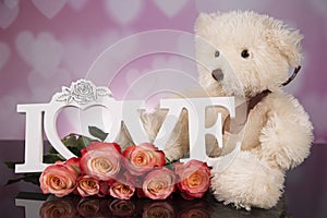 A bouquet of haber roses and a teddy bear mascot. Valentine`s Day