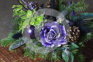 Bouquet has Christmas tree branches and artificial flowers.