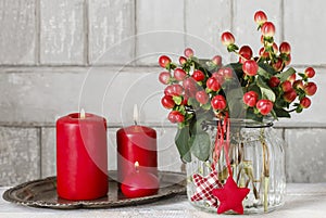 Bouquet of hypericum plants twigs with red berries