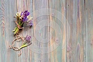 Bouquet of iris flowers Iridodictyum on a wooden background