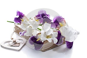 Bouquet of irises on the old book on white background. Isolated object