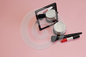 A bouquet of large white or tea-colored roses on a pink backgroundmorning makeup, standing mirror, powder makeup brush and red lip