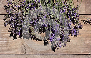 Bouquet of lavender flowers on a wooden background. Lots of fragrant summer flowers. Copy space