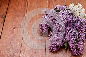Bouquet of lilac on brown wooden background