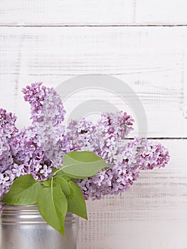 Bouquet of lilac flowers on white wooden background