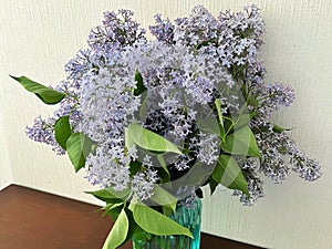 Bouquet of lilacs in a vase on the table