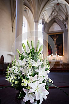 Bouquet of lilies and snapdragons in church
