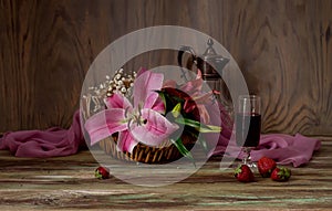 Bouquet of lilies, wine and strawberries close-up