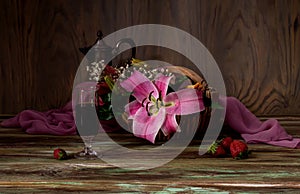 Bouquet of lilies, wine and strawberries close-up