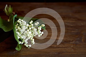 A bouquet of lyses on a wooden table. With copy space