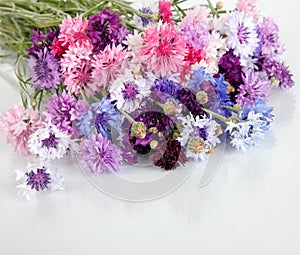 Bouquet of many beautiful multi-colored cornflowers flowers in vase photo