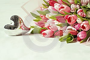 Bouquet of multi-colored tender spring tulip flowers and a shining heart.