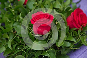 Bouquet of multicolored roses . Red flower picture close up in the pink bouquet. The flower`s petal . Bouquet of fresh 2 red rose