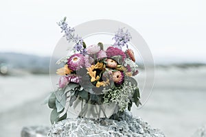 Bouquet of Mums, Eucalyptus, and LIlacs on a Stone Rock at Half Moon Bay, California