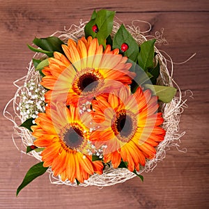 Bouquet of orange gerberas with small white blooms