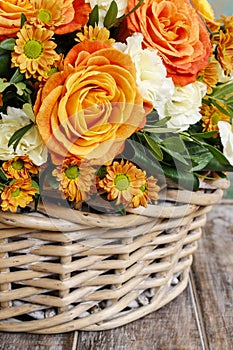 Bouquet of orange roses and ivory carnation flowers