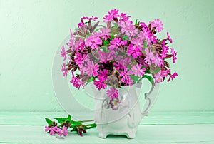 Bouquet of pink flowers on green background