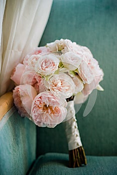 Bouquet of pink peonies propped on a chair