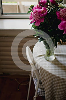 bouquet of pink peonies in a vase on the table