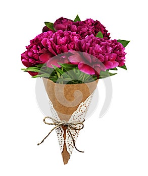 Bouquet of pink peony flowers in a craft paper cornet