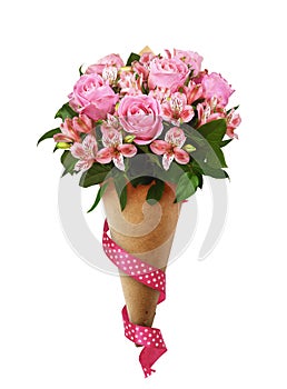 Bouquet of pink roses and alstroemeria flowers in a brown craft paper cornet with silk ribbon isolated on white