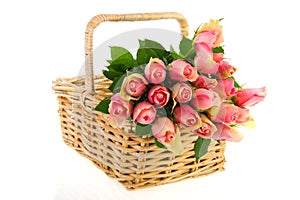 Bouquet pink roses in cane basket