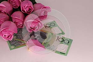 Bouquet of pink roses with cash on a white background with space for text